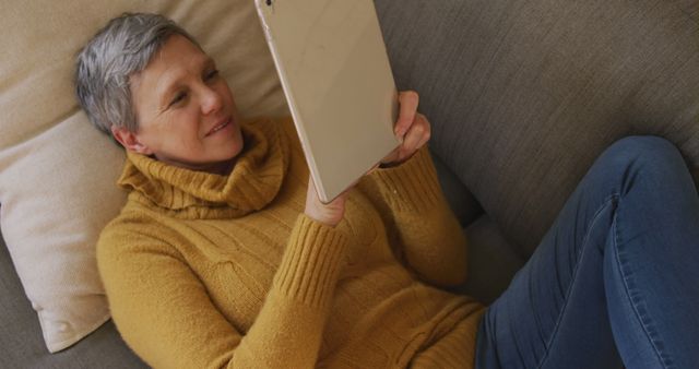 Senior Woman Relaxing on Couch with Tablet Device - Download Free Stock Images Pikwizard.com