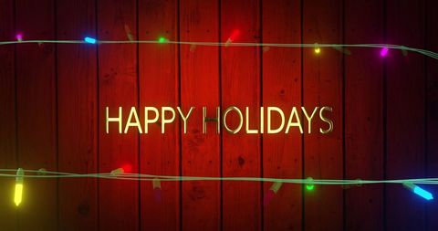 Festive Happy Holidays Text with Colorful Fairy Lights on Wood