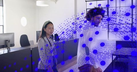 Colleagues walking through augmented reality data overlay in modern open-plan office