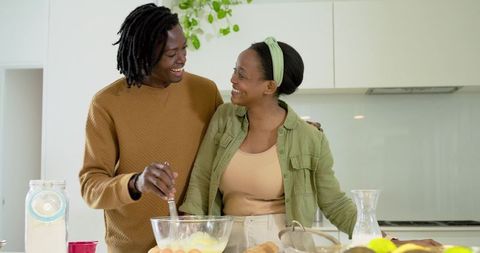 African American Couple Baking Together in Sunlit Modern Kitchen, Preparing Breakfast