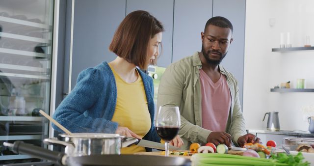 Image of diverse couple preparing food together in kitchen at home - Download Free Stock Photos Pikwizard.com