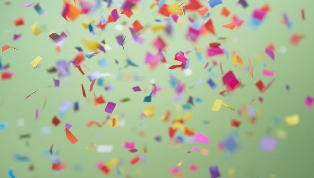 Vibrant Confetti Falling on Soft Green Background