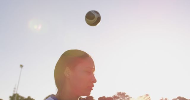Young Woman Heading Soccer Ball During Outdoor Practice - Download Free Stock Images Pikwizard.com