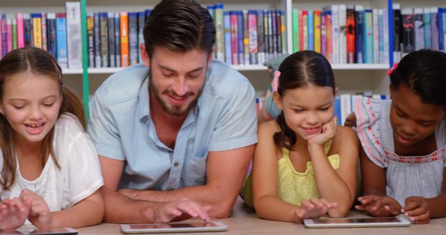 Teacher with Diverse Group of Schoolchildren Using Tablets in Library - Download Free Stock Images Pikwizard.com