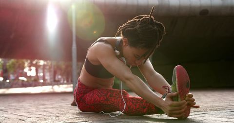 Focused Athlete Stretching Outdoors at Sunrise