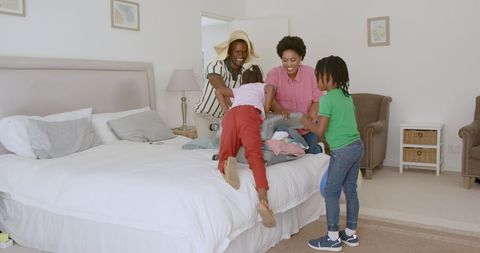 Family Joyfully Packing for Vacation in Bedroom