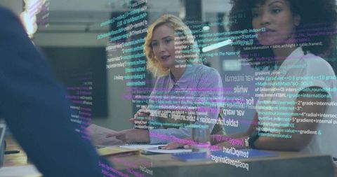 Female-led team reviewing code and documents during collaborative tech meeting