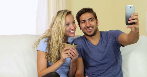 Couple Capturing Moments with Smartphone in Living Room