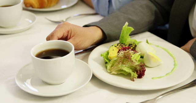 Businessperson enjoying healthy breakfast with tea and salad - Download Free Stock Photos Pikwizard.com