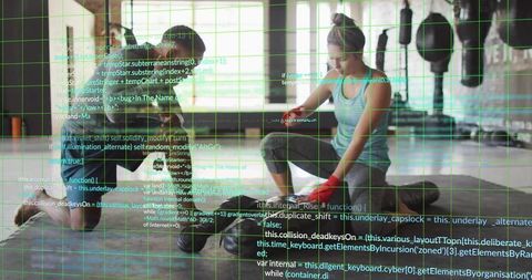 Couple stretching in tech-fused gym with digital code overlay and green grid