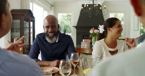 Friends Celebrating Together at Dining Table Cheerful Atmosphere