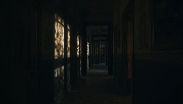 Dark Mysterious Hallway with Vintage Decor and Atmospheric Lighting