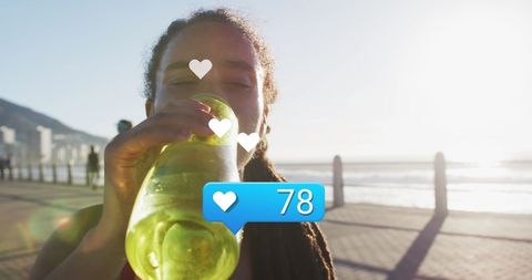 Athlete enjoying refreshment with heart icon feedback outdoors