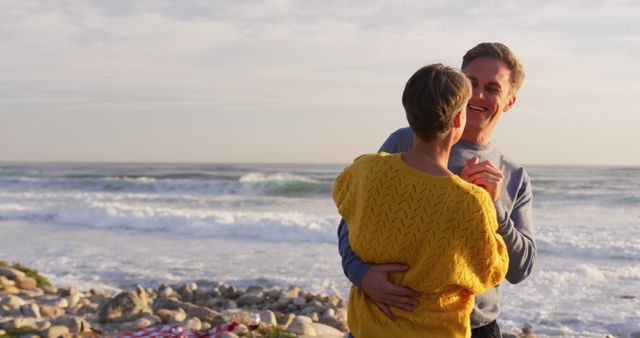 Happy Couple Dancing on Rocky Beach During Sunset - Download Free Stock Images Pikwizard.com