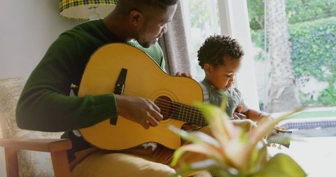 Father and Son Bonding with Acoustic Guitar at Home