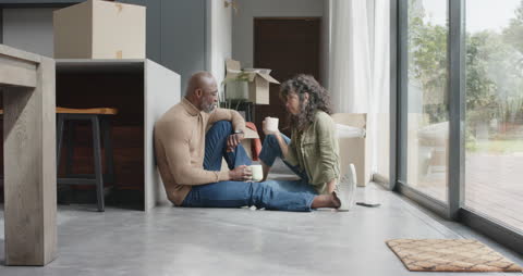 Joyful Couple Relaxing with Coffee During Home Move
