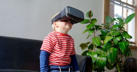 Young Boy Exploring Virtual Reality in Living Room Setting