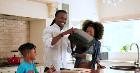 Happy Family Preparing Lunch in Kitchen for School Day Start