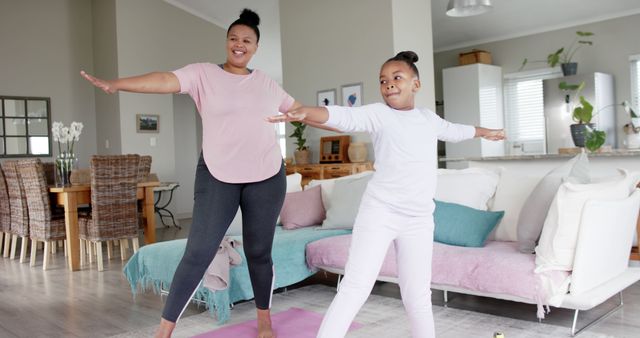 Mother and Daughter Practicing Yoga Together in Cozy Living Room - Download Free Stock Images Pikwizard.com