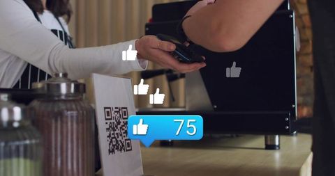 Barista Accepting Contactless Mobile Payment at Cafe Counter with QR Code and Social Likes
