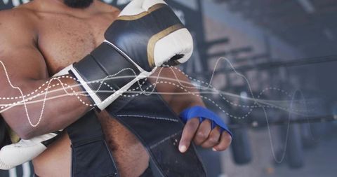 Shirtless boxer training with gloves and chest pad, motion waveform emphasizing intense focus