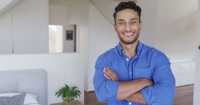 Confident Man Smiling with Arms Crossed at Home - Download Free Stock Images Pikwizard.com