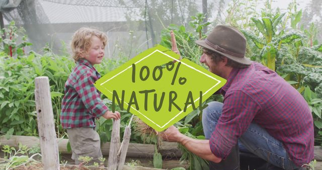 Image of 100 percent natural text over caucasian father and son gardening. Global ecology, organic and digital interface concept digitally generated image.