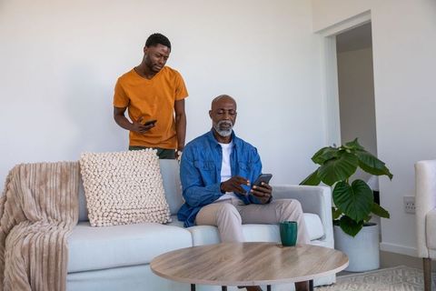 African American Father and Son Bonding with Smartphones At Home