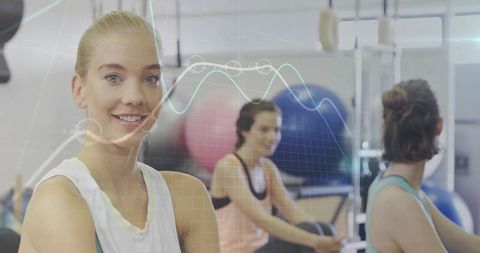 Smiling Woman at Fitness Center with Data Visualization