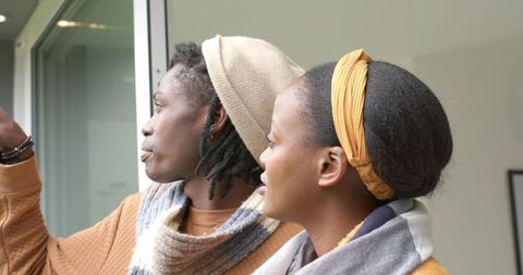 African American Couple Pointing Through Sliding Door, Intimate Windowlight Lifestyle