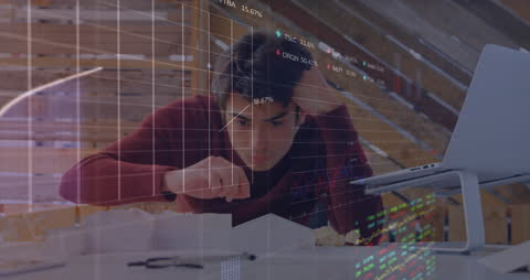 Businessman Analyzing Financial Charts with Focus and Determination