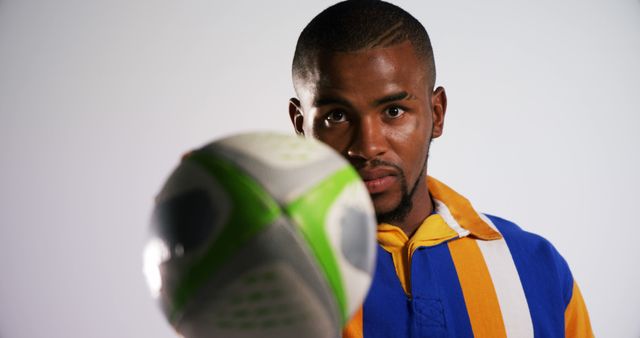 Focused Soccer Player Holding Ball Up Close - Download Free Stock Images Pikwizard.com