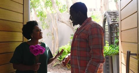 Couple sharing romantic moment with pink flowers