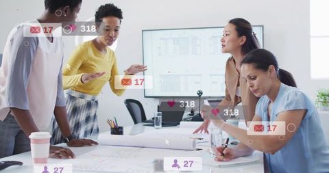 Design team collaborating over blueprints with social media overlays in bright studio room