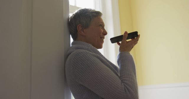 Senior Woman Using Smartphone Voice Assistant in Cozy Home - Download Free Stock Images Pikwizard.com