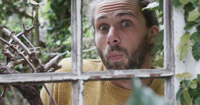 Surprised Man Looking Through Window Pane in Garden - Download Free Stock Images Pikwizard.com