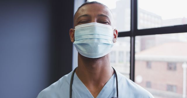 Confident Male Healthcare Worker Wearing Medical Face Mask Indoors - Download Free Stock Images Pikwizard.com