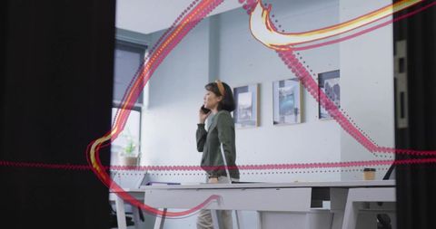 Focused businesswoman communicating on phone in modern office