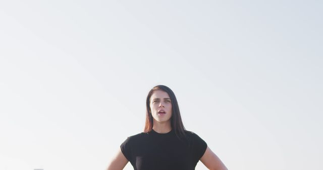 Confident Young Woman Standing Outdoors Under Bright Sky - Download Free Stock Images Pikwizard.com