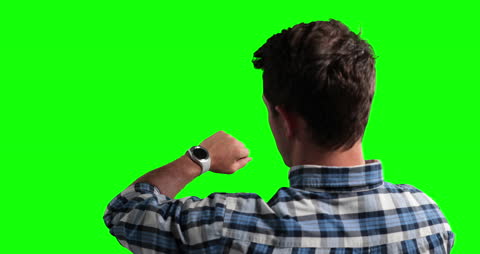 Man Checking Smartwatch Against Bright Green Background