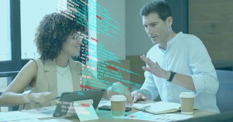 Two Professionals Collaborating on Software Project in Modern Office