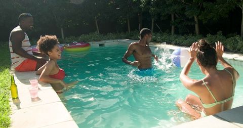 Group of Friends Enjoying Sunny Day at Backyard Pool