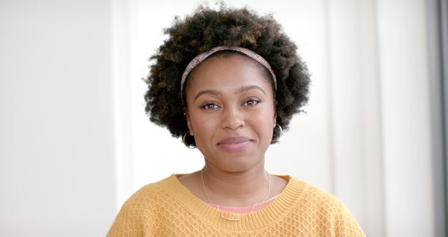 Smiling Woman with Natural Hair Wearing Yellow Sweater Indoors - Download Free Stock Images Pikwizard.com