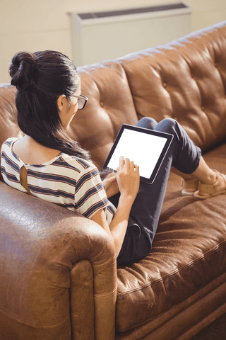 Businesswoman Relaxing on Sofa with Tablet Transparent Screen - Download Free Stock Videos Pikwizard.com