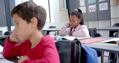 Children concentrating on lessons in classroom environment