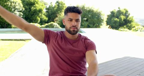 Man Relaxing Outdoors on Modern Deck with Nature View