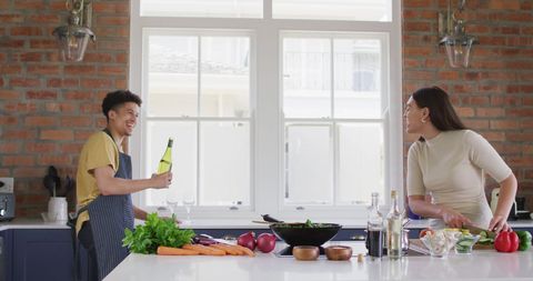 Couple Enjoying Cooking and Wine in Modern Kitchen - Download Free Stock Images Pikwizard.com