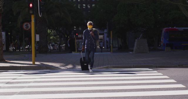 Senior Man with Trolley Bag Crossing Urban Street Crosswalk - Download Free Stock Images Pikwizard.com