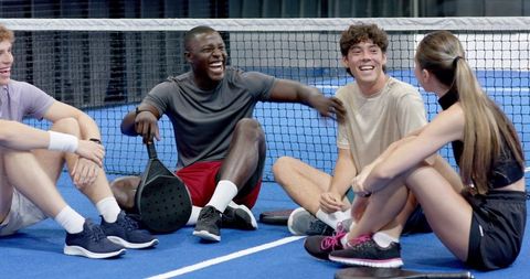 Diverse Friends Enjoy Light-Hearted Moment on Padel Court