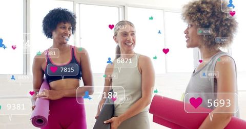 Diverse women holding yoga mats chatting and smiling with social media likes overlay